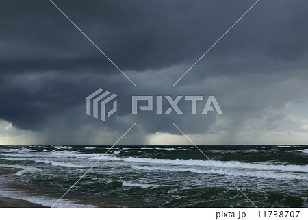 rain over Baltic sea - storm waves and overcast thunderstorm sky over water 11738707