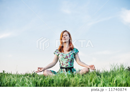 Pretty woman meditate in the park Pretty woman meditate in the park 11740874