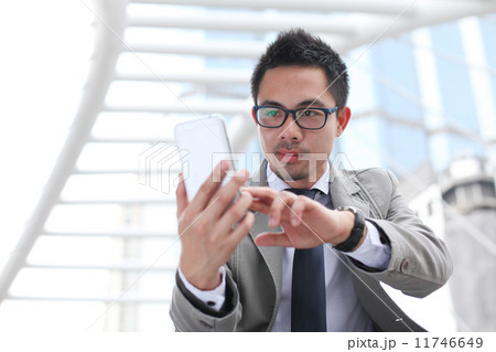 Asian business man speaking mobile phone 11746649