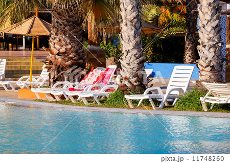sunloungers on swimming pool sunloungers on swimming pool 11748260