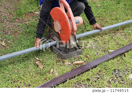 Worker cutting metal with cutting machine Worker cutting metal with cutting machine 11749515