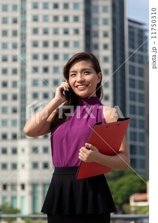 Young Asian businesswoman using cellphone outdoor 11750310