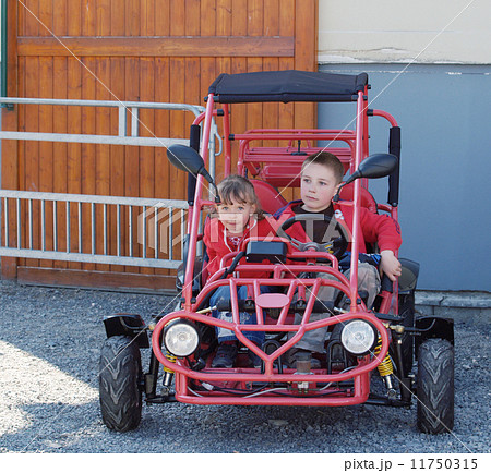Brother and sister sitting in buggy Brother and sister sitting in buggy 11750315