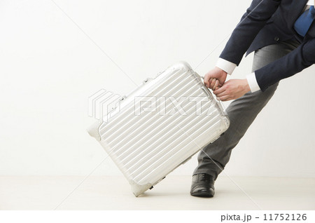 スーツケースを引くスーツの男性 11752126
