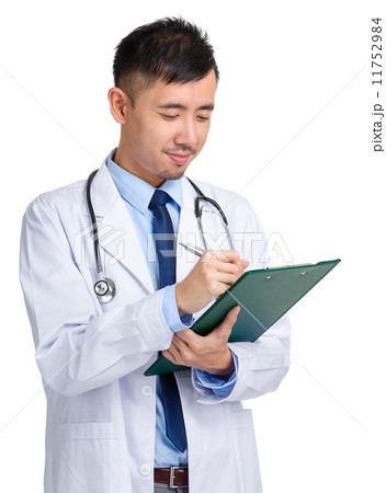 Male doctor writing on folder 11752984