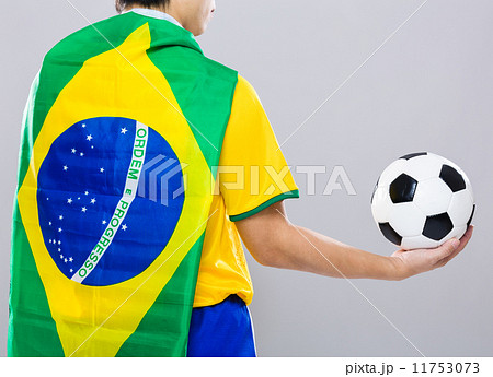 Backview of football player wear with Brazil flag and hold footb 11753073