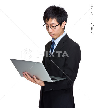 Businessman look at laptop computer Businessman look at laptop computer 11753410