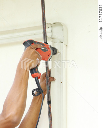 worker using drill worker using drill 11757832