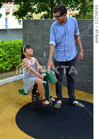 Asian indian bother accompanying his young sister at the playground Asian indian bother accompanying his young sister at the playground 11759245