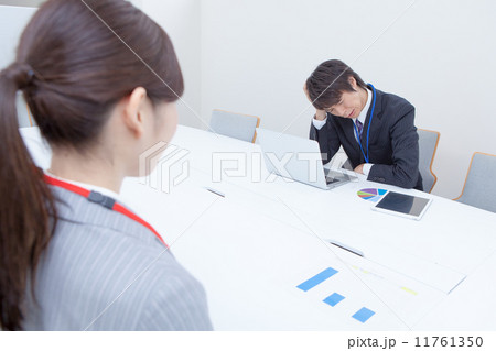 会議中に悩む男性社員 11761350