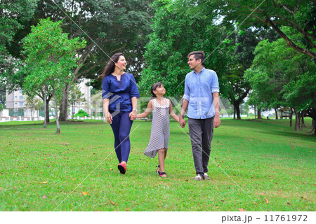 An asian family having an enjoyable time scrolling in the park An asian family having an enjoyable time scrolling in the park 11761972