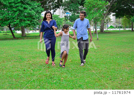 An asian family having an enjoyable time scrolling in the park An asian family having an enjoyable time scrolling in the park 11761974