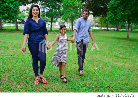 An asian family having an enjoyable time scrolling in the park An asian family having an enjoyable time scrolling in the park 11761975
