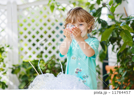 Happy little boy making experiment with colorful water and soap Happy little boy making experiment with colorful water and soap 11764457