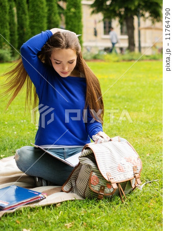 Beautiful young student girl in a city park on summer day Beautiful young student girl in a city park on summer day 11764790