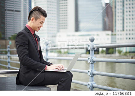 Businessman with Notebook in the City Businessman with Notebook in the City 11766831