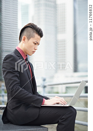 Businessman with Notebook in the City Businessman with Notebook in the City 11766832