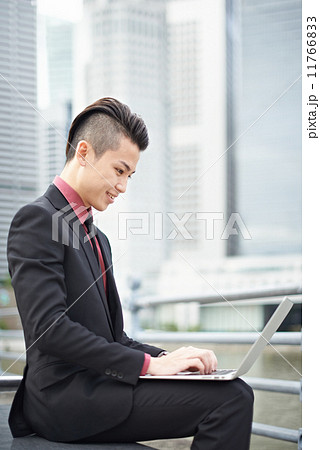 Businessman with Notebook in the City Businessman with Notebook in the City 11766833