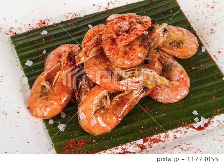 fried black tiger prawns with herbs and spices on banana leaf 11773055