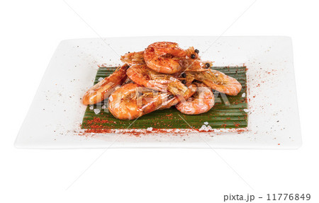 fried black tiger prawns with herbs and spices on banana leaf fried black tiger prawns with herbs and spices on banana leaf 11776849