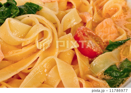 tasty pasta with cream, salmon, cheese and parsley close up tasty pasta with cream, salmon, cheese and parsley close up 11786977