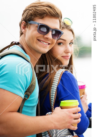 Couple tourists with map and coffee cups near river in a city Couple tourists with map and coffee cups near river in a city 11802495