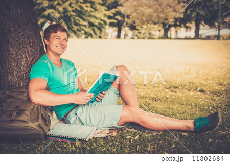 Handsome man student in a city park on summer day 11802684