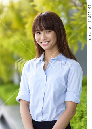 Portrait of successful young office lady smiling along promenade shallow dept of field 11805147