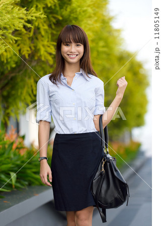 Successful young office lady going to work walking along promenade shallow dept of field Successful young office lady going to work walking along promenade shallow dept of field 11805149