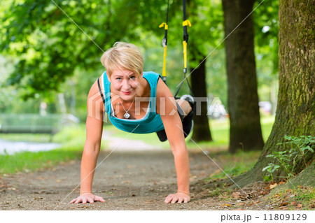 woman doing suspension sling trainer sport 11809129