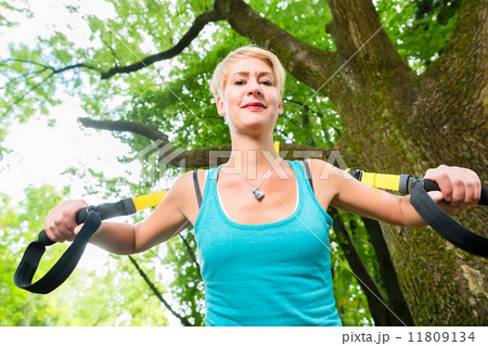 woman doing suspension sling trainer sport 11809134