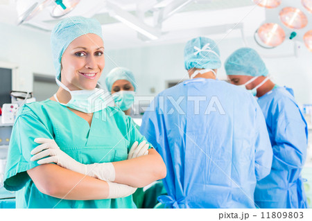 Surgeons operating patient in operation theater Surgeons operating patient in operation theater 11809803
