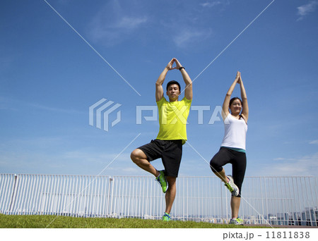 Young Asian Adults doing yoga in the city Young Asian Adults doing yoga in the city 11811838