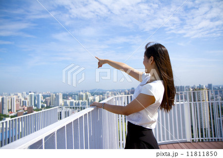 Young Asian woman enjoying the city skyline view. 11811850