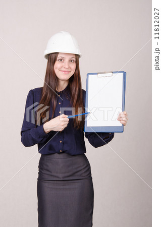 Beautiful girl shows a pencil inscription on folder 11812027