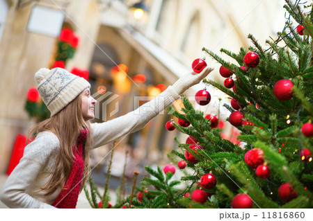 Girl with decorated Christmas tree Girl with decorated Christmas tree 11816860