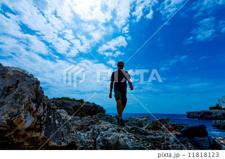 man walking on rocks 11818123