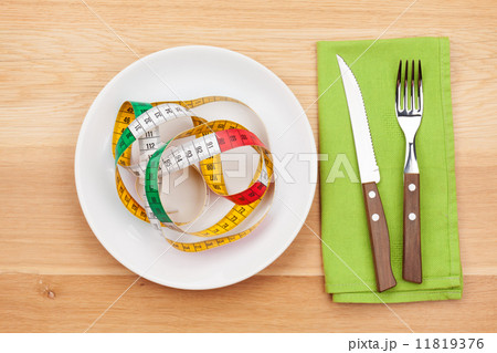 Plate with measure tape, knife and fork. Diet food 11819376