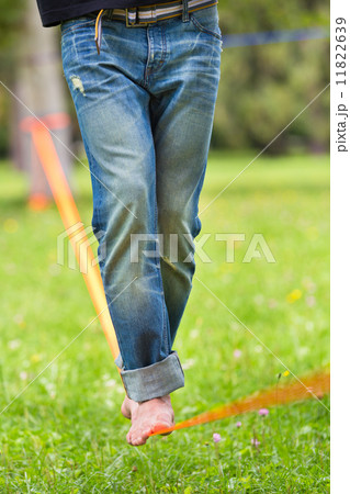 Slack line in the city park. Slack line in the city park. 11822639