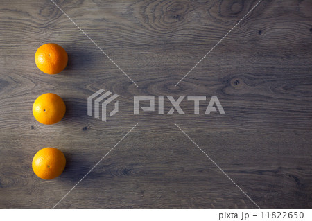 Three Oranges are on empty dark Wooden Table 11822650