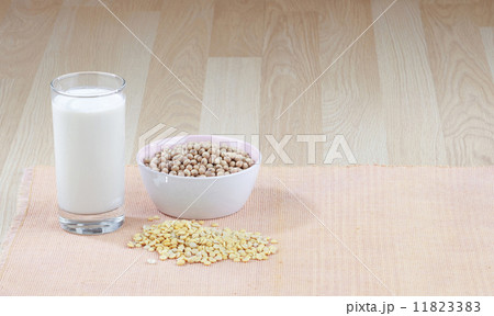 glass of soy milk with a bowl of raw soybean 11823383