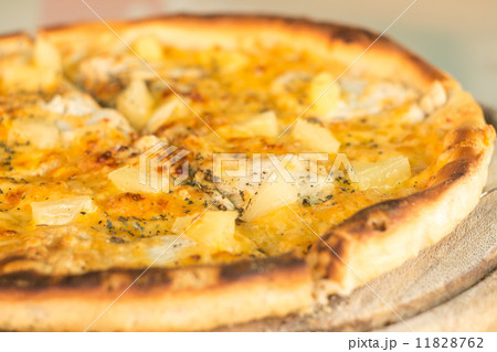 Baked cut pizza with pineapple and meat on wooden board Baked cut pizza with pineapple and meat on wooden board 11828762