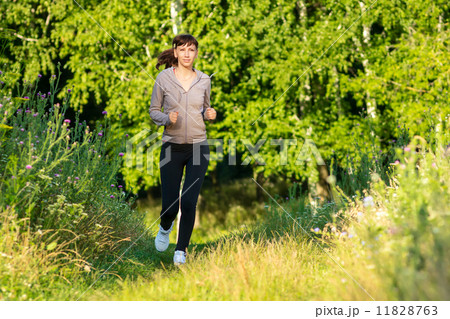 Young woman jogging in summer morning park 11828763