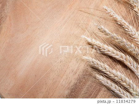 Wheat ears on a wooden background. Wheat ears on a wooden background. 11834279