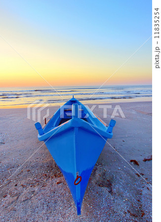 fishing boat on the seashore at sunrise 11835254