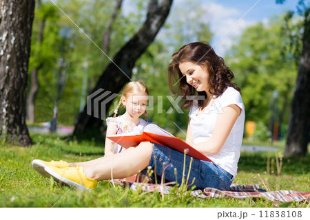 girl and a young woman reading a book together girl and a young woman reading a book together 11838108