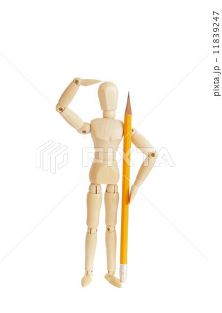 Cute wooden figure holding pencil and looking 11839247