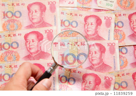 chinese money (currency) and magnifying glass 11839259
