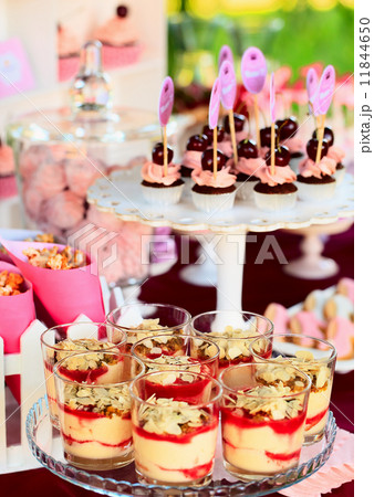 Sweet holiday buffet with cupcakes and tiramisu glasses 11844650