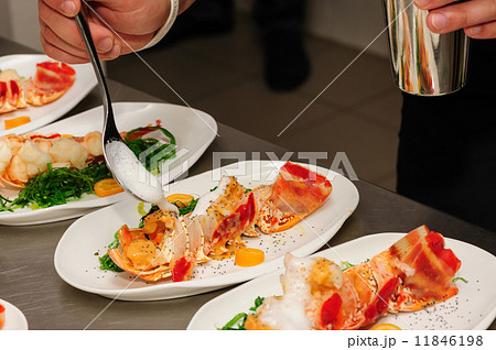 Decorating cooked lobster on plate 11846198